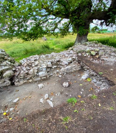 Partially excavated site known as Cutting 2, with stone remains and a large