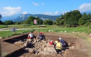 Archaeology students using tools to excavate soil at a historical site in Vicenza, Italy, as part of a hands-on field school experience.