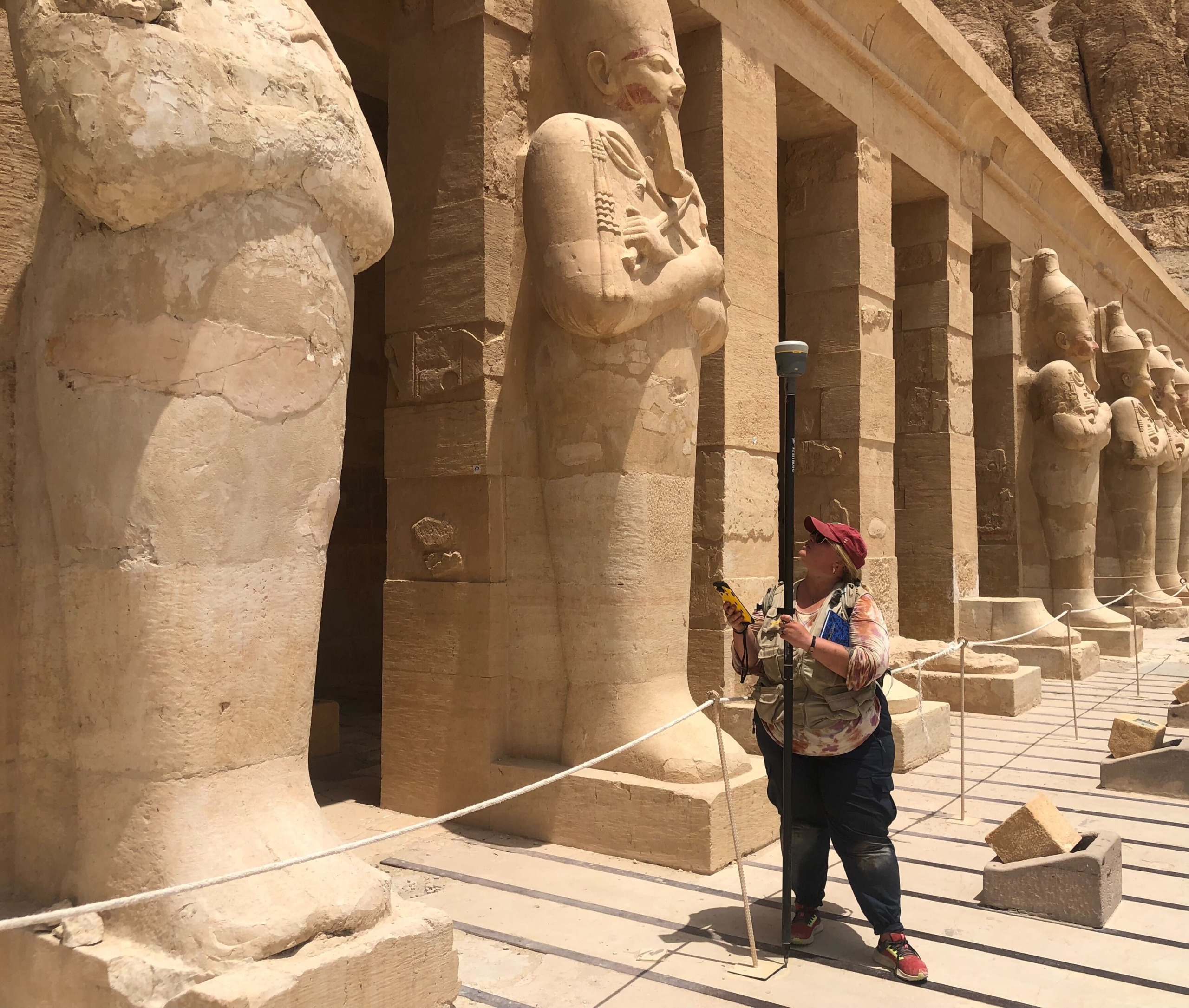 IFR Director of Programs Kate conducting archaeological survey work among ancient statues at a temple site in Luxor, Egypt.